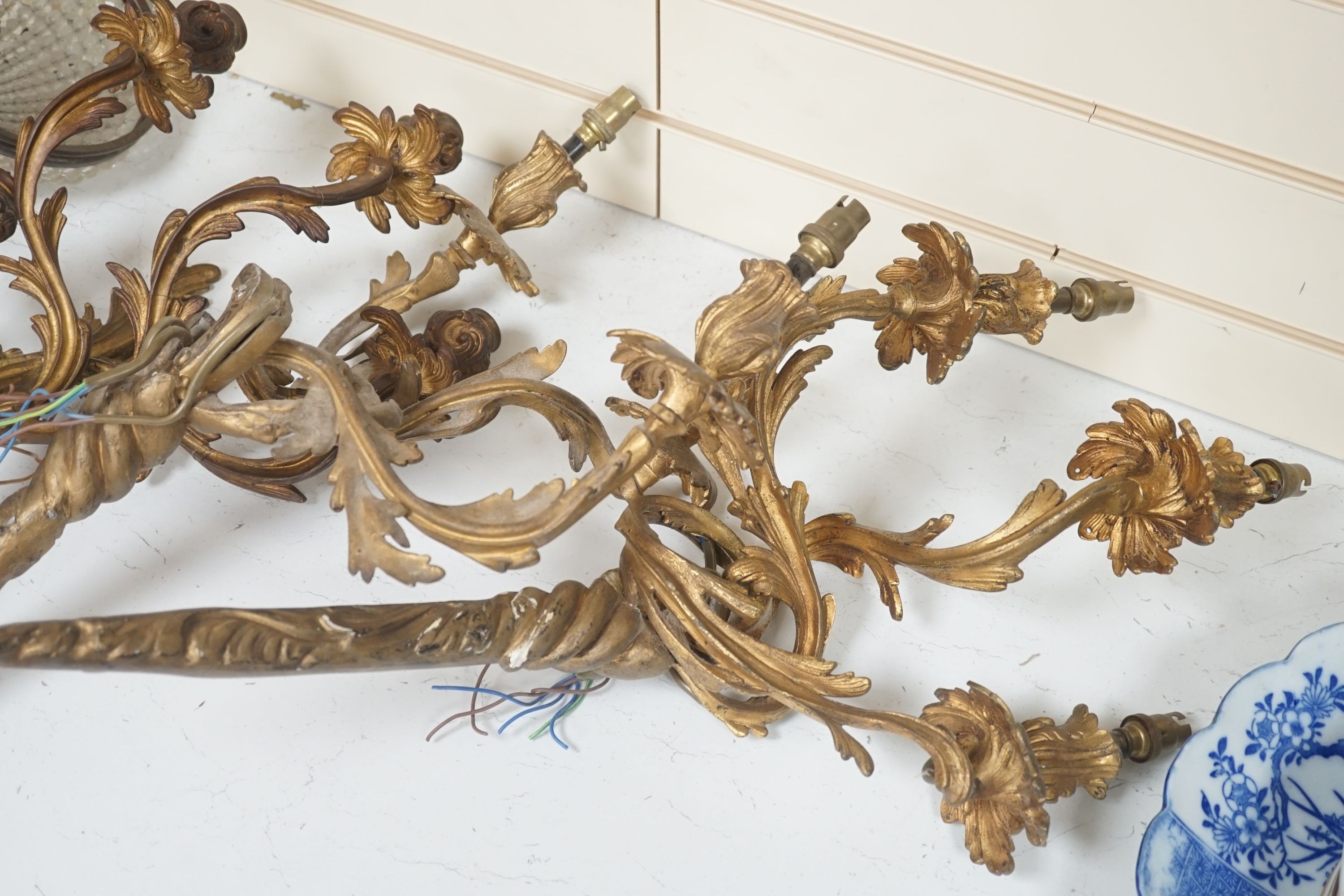 A pair of gilt metal 3 branch wall sconces, a pair of gilt plaster ditto and other light fittings